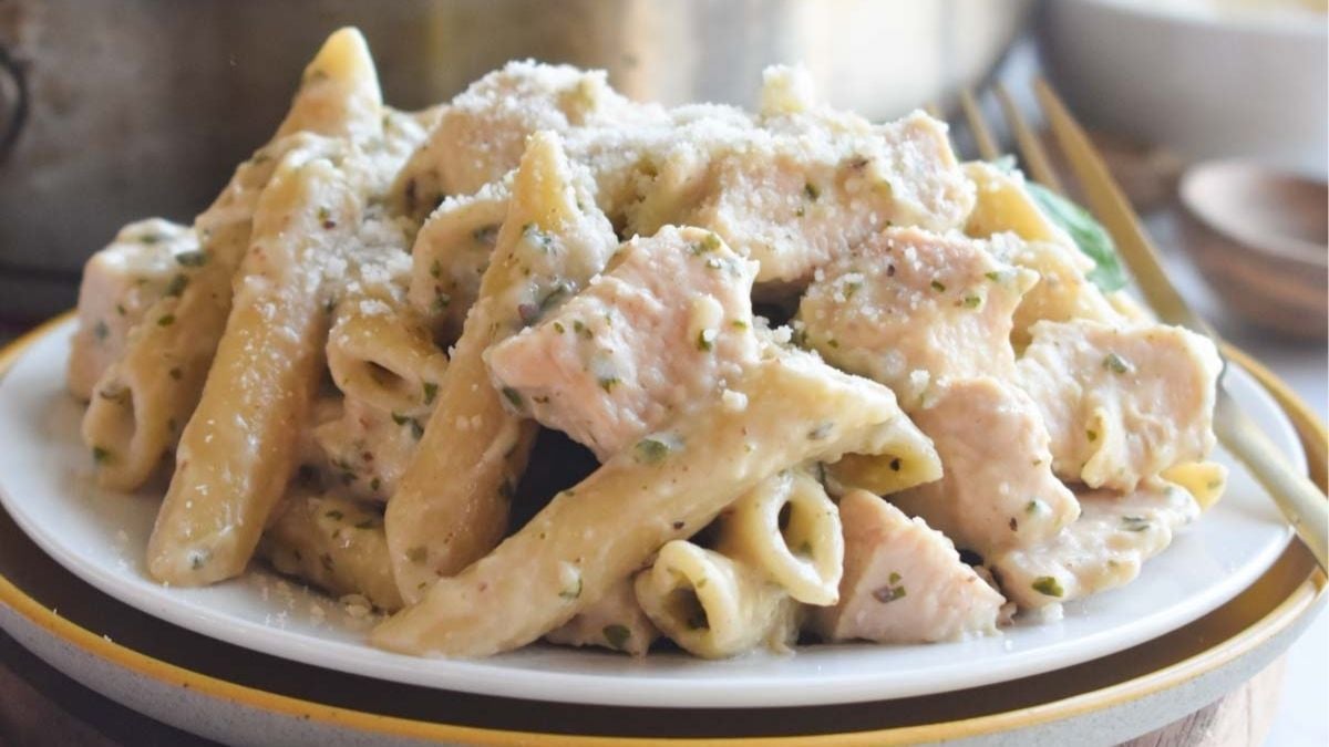 One pot chicken pesto pasta on a white plate.