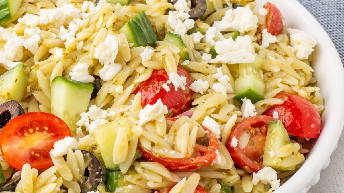 Orzo pesto salad in a white bowl.