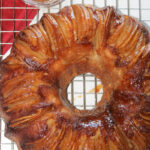 Caramel apple upside down bundt cake on wire cooling rack.