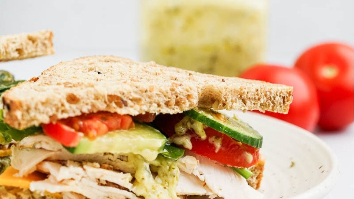 Pesto turkey sandwich on a plate.