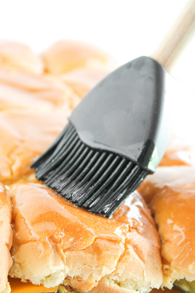 Top of the buns are brushed with butter mixture.