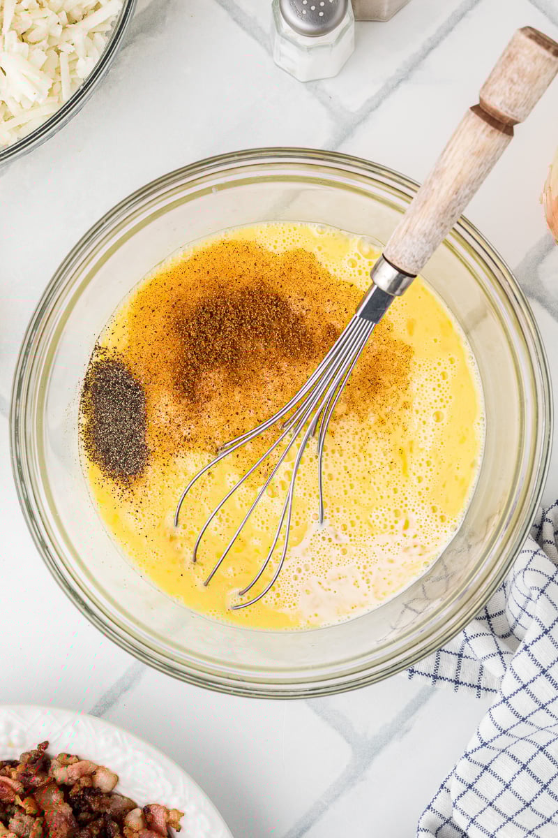 Seasonings aded to the beaten eggs in mixing bowl.