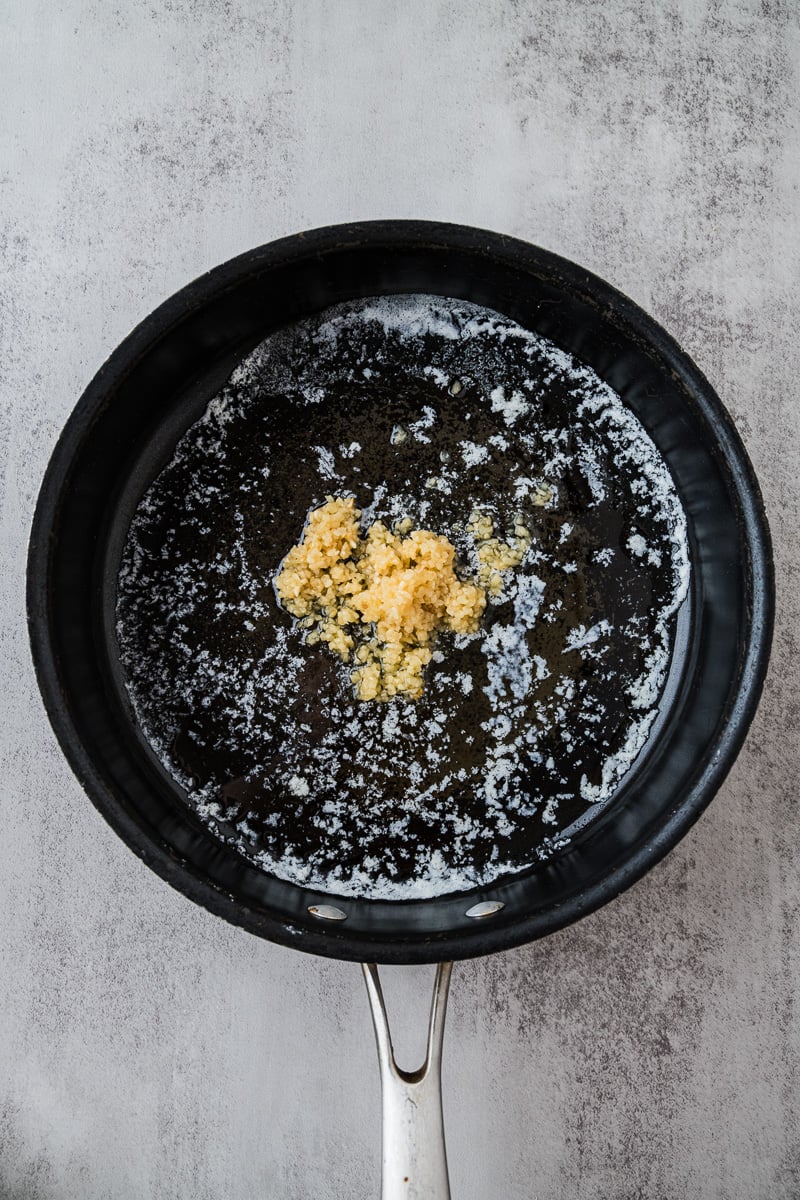 Garlic is added to skillet with butter.