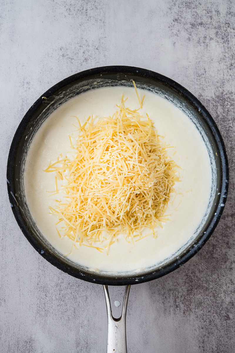Parmesan cheese is added to the skillet.