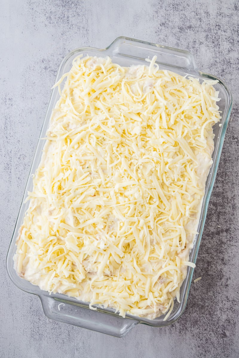 Remaining mozzarella and parmesan cheese are added to the top of the lasagna.