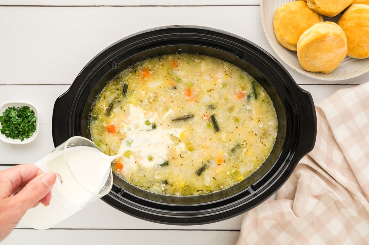 Heavy cream is poured into crockpot.