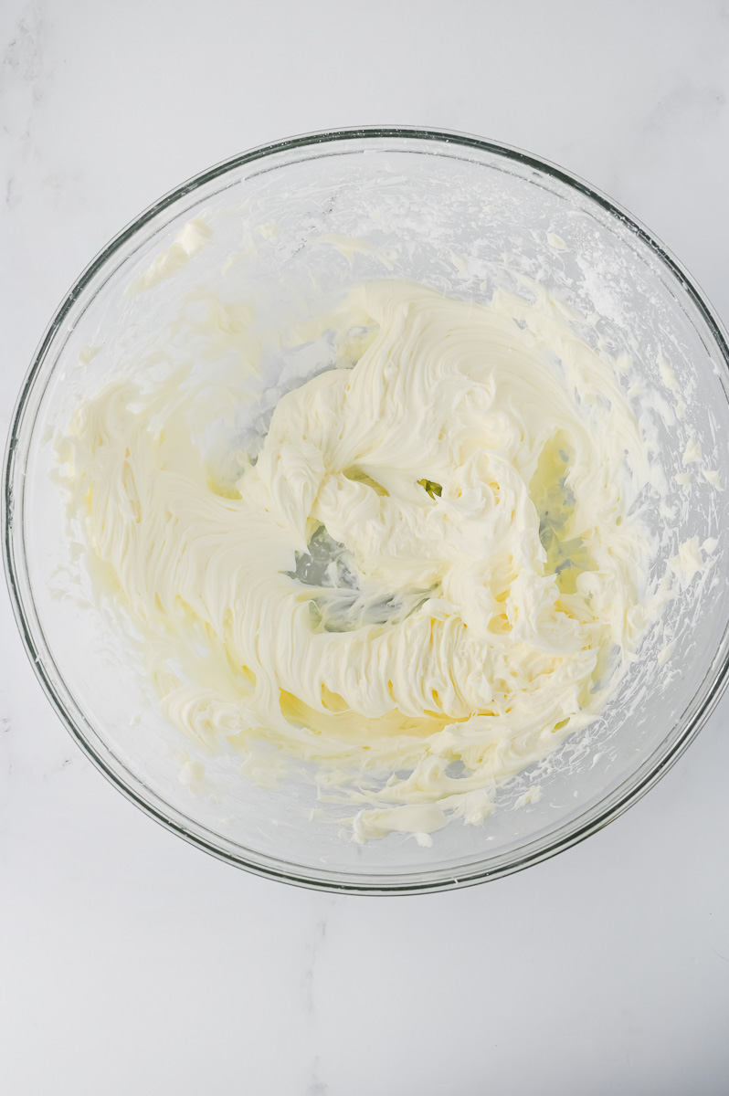Cream cheese mixture in glass mixing bowl.