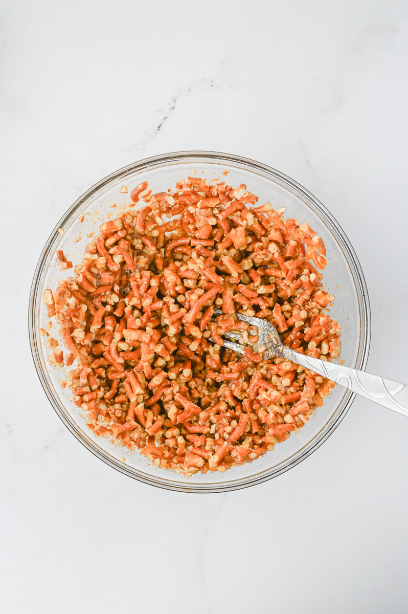 Butter, pretzels and sugar in mixing bowl with fork for stirring.
