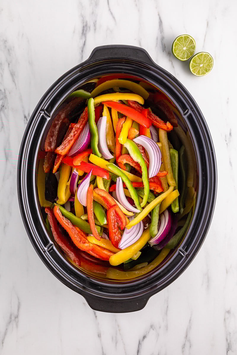 Peppers are added to the crockpot.