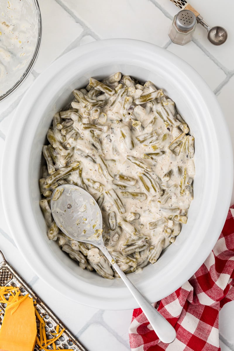 Green bean and soup mixture is spread into the bottom of crockpot.