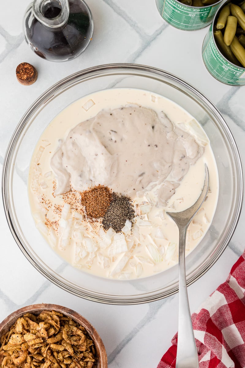 Seasonings and cream soup in glass mixing bowl.