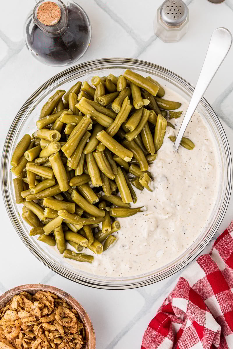 Drained green beans are added to the mixing bowl.