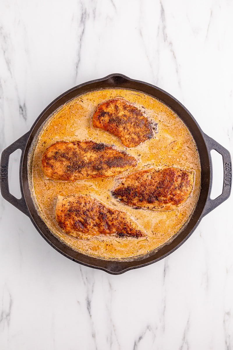 Chicken is adde back to the skillet.