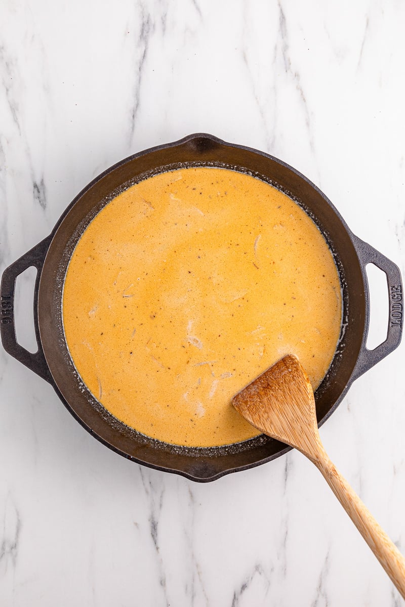 Cream is added to the skillet.