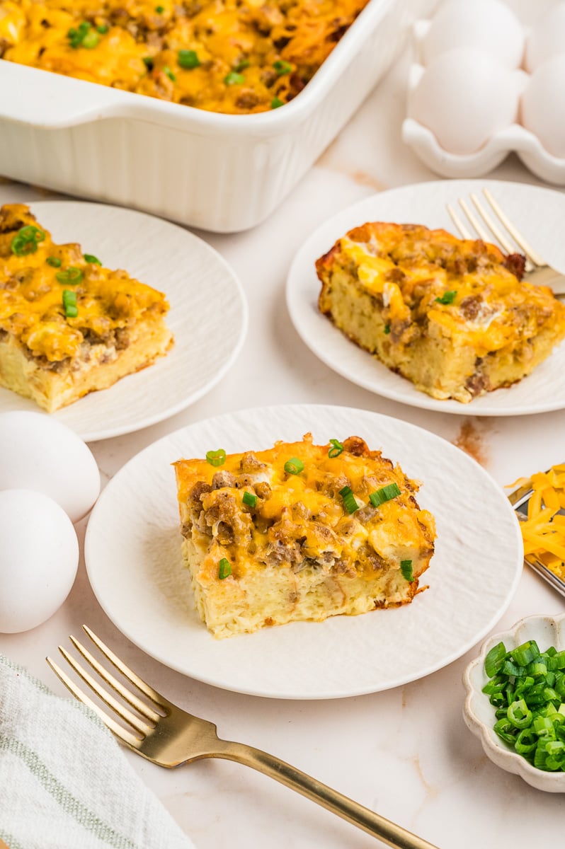 Overnight pancake casserole served on white plates.