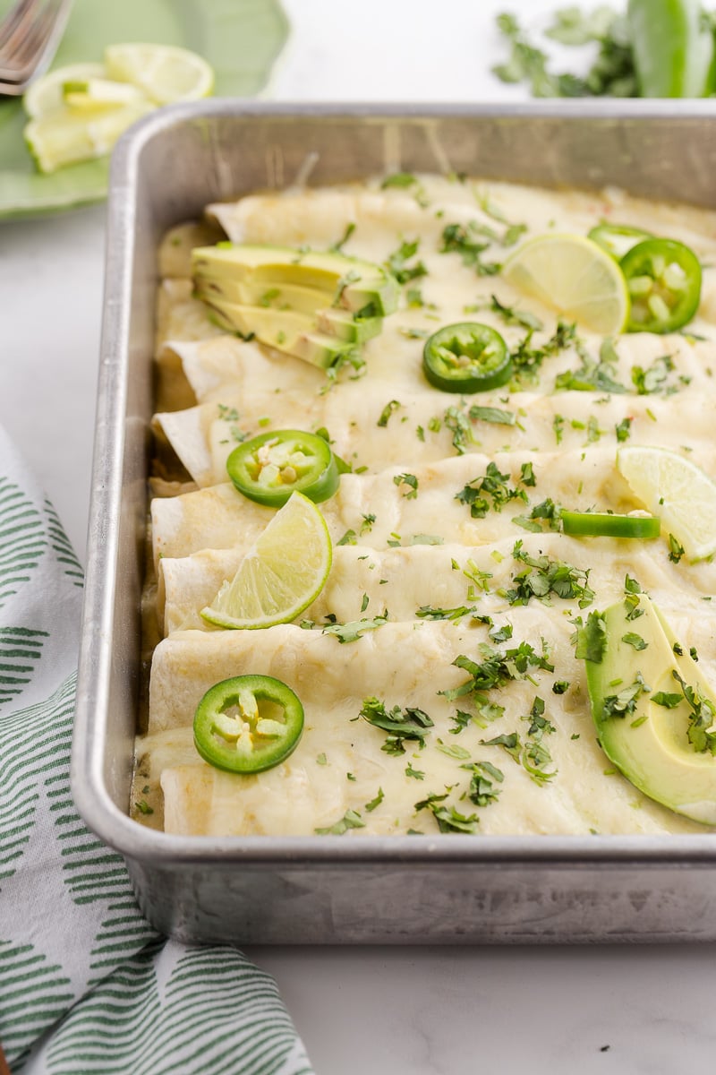 Green chili enchilada chicken casserole in baking dish ready to be served.