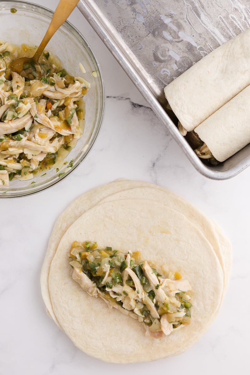 Filling is spooned over flour tortillas.