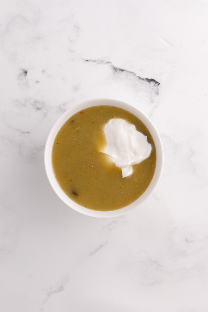 Enchilad sauce with sour cream in mixing bowl.