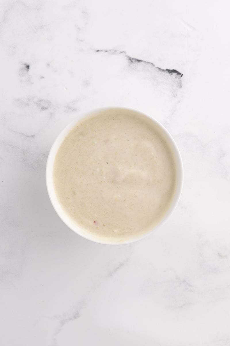 Enchilad sauce with sour cream in mixing bowl.