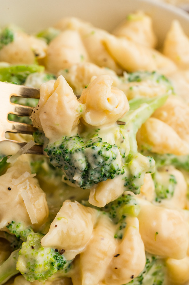 Broccoli mac andd cheese close up image of bite on fork.