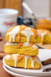 Three scones stacked on a plate.
