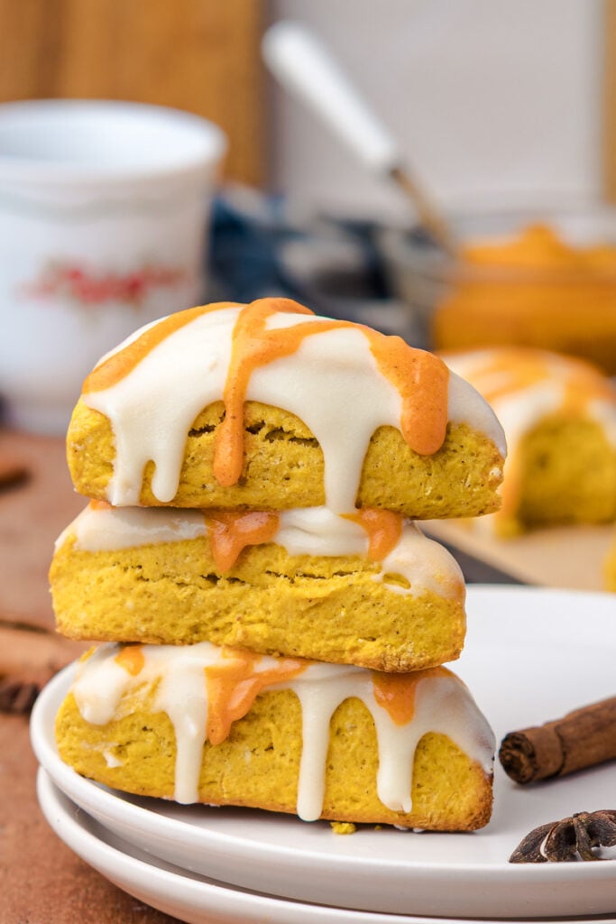 Three scones stacked on a plate.
