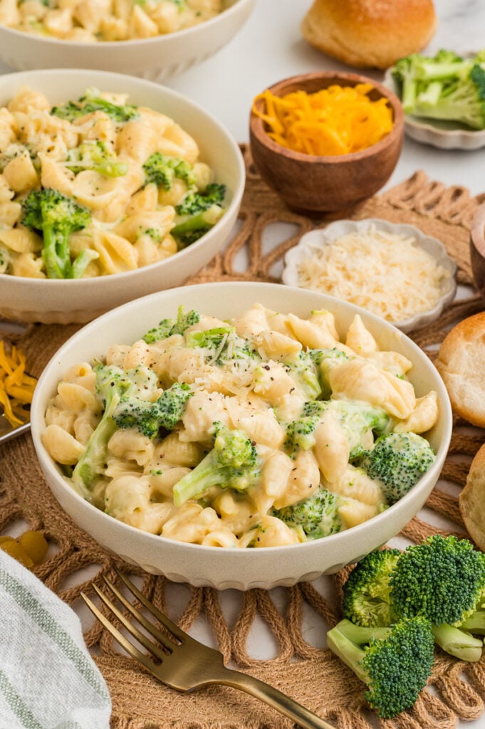 Broccoli cheddar mac and cheese in white bowl.