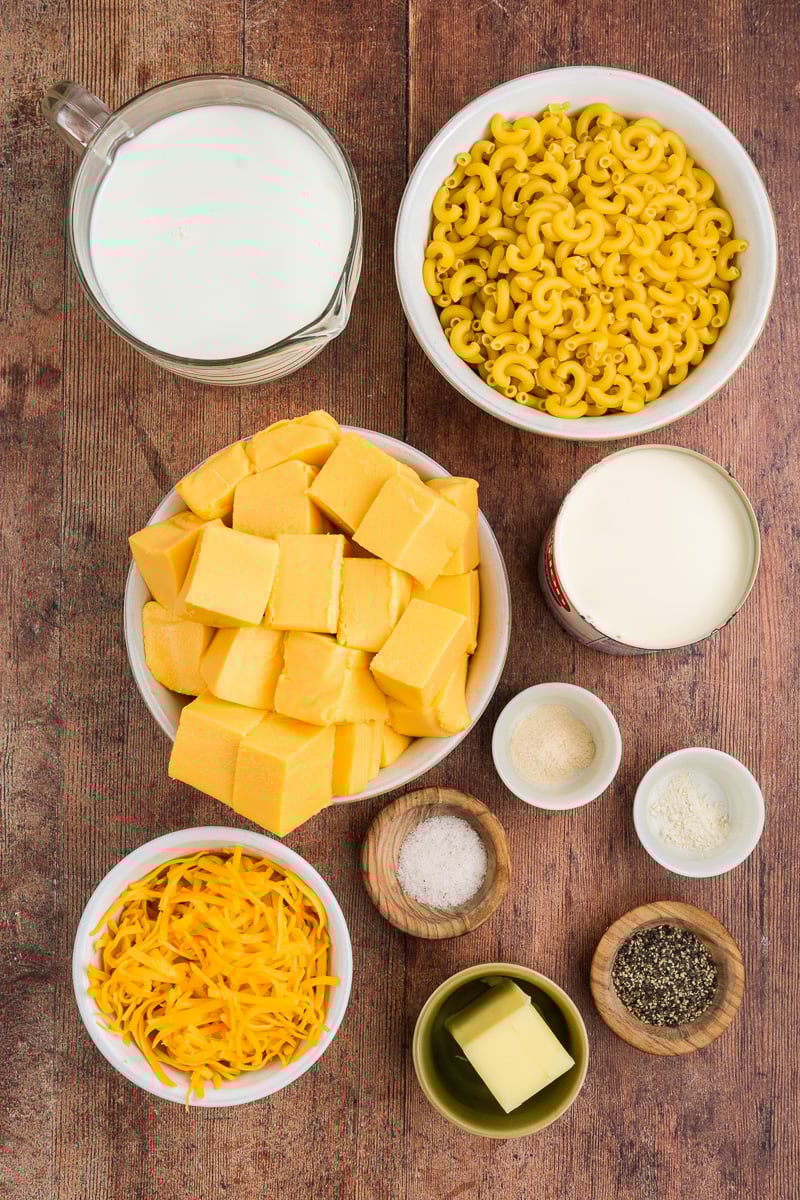 Ingredients for slow cooker mac and cheese in bowls on counter.