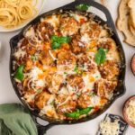Chicken parmesan meatballs in skillet.