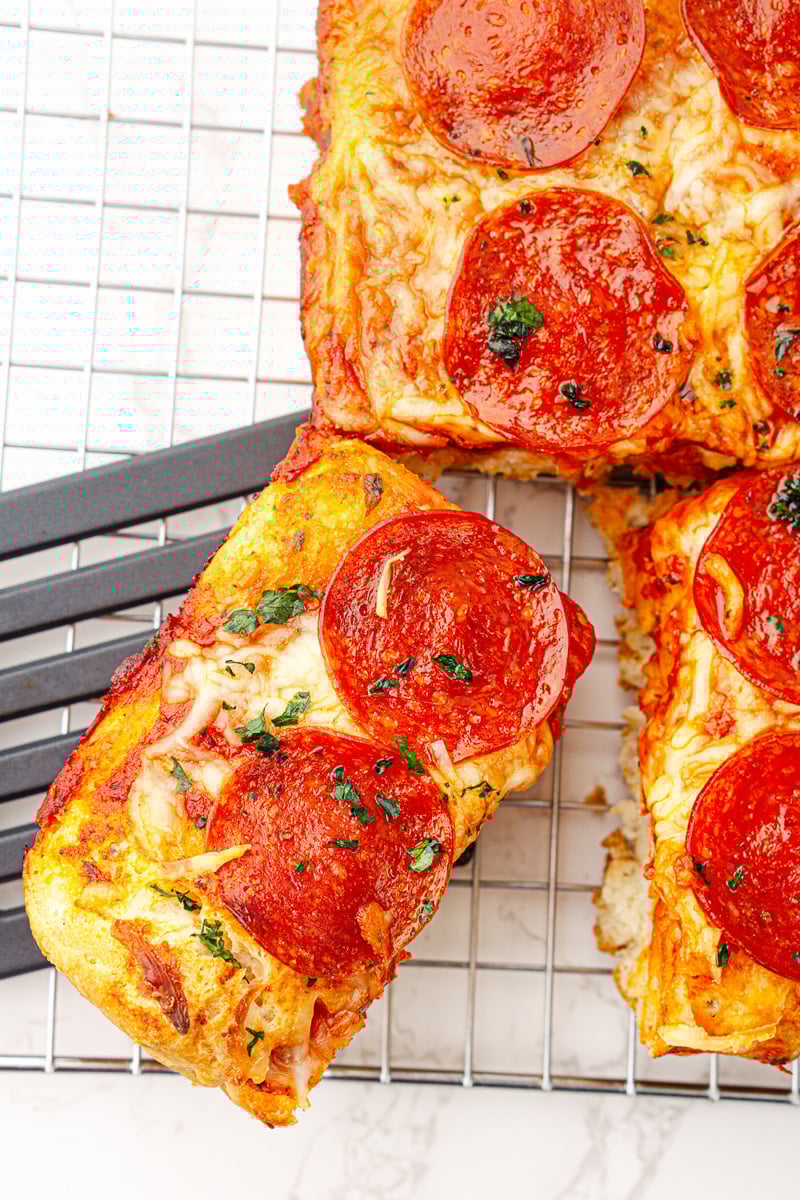 Overhead view of piece of pizza bake removed from the casserole.