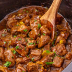 Overhead view of crockpot Mississippi steak bites in slow cooker.
