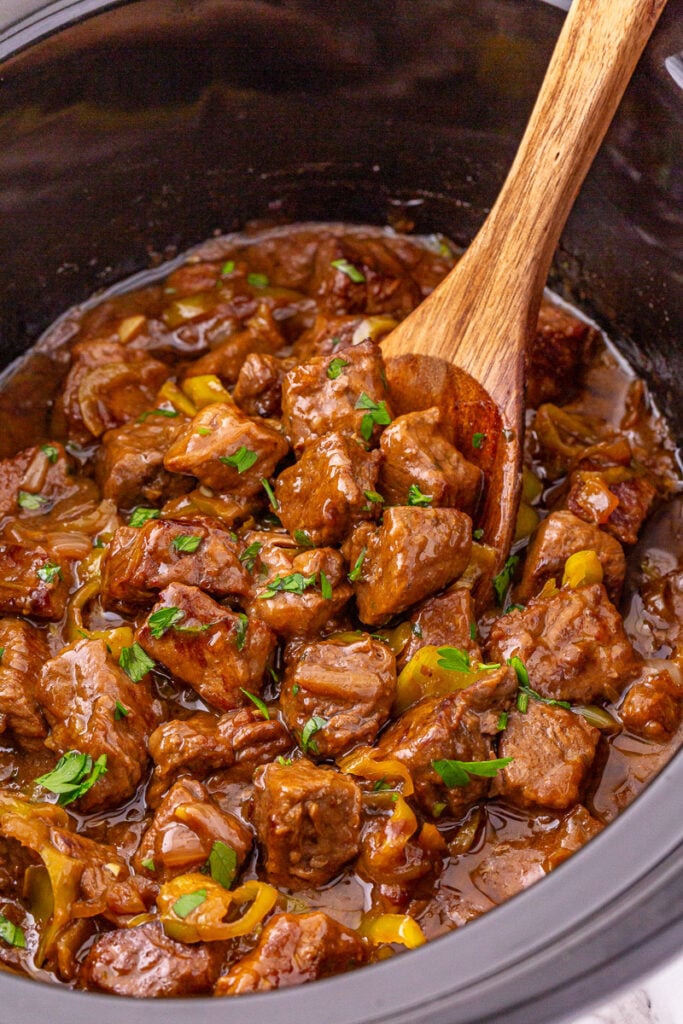 Overhead view of crockpot Mississippi steak bites in slow cooker.