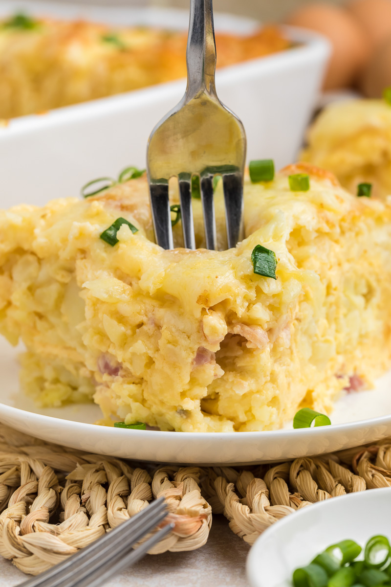 Breakfast tater tot casserole served on a white plate.