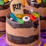 Best Oreo dirt dessert cups on Halloween napkins on table.