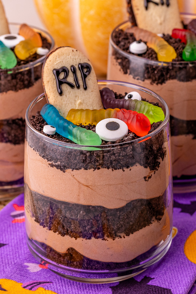 Best Oreo dirt dessert cups on Halloween napkins on table.
