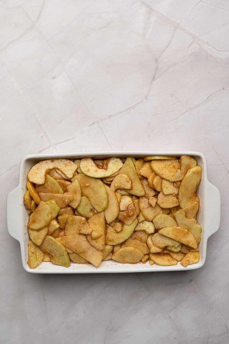 Apple mixture is spread into the bottom of baking dish.