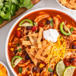 Chicken tortilla soup in a white bowl.