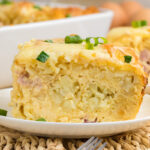 Tater tot breakfast casserole served on a white plate.