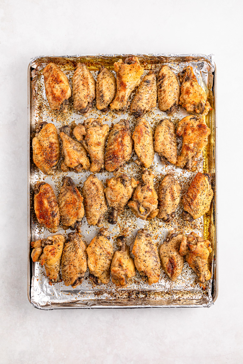 Chicken wings on baking sheet.