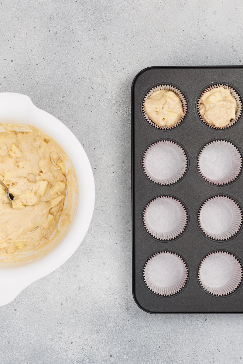 Muffin batter in muffin tin.