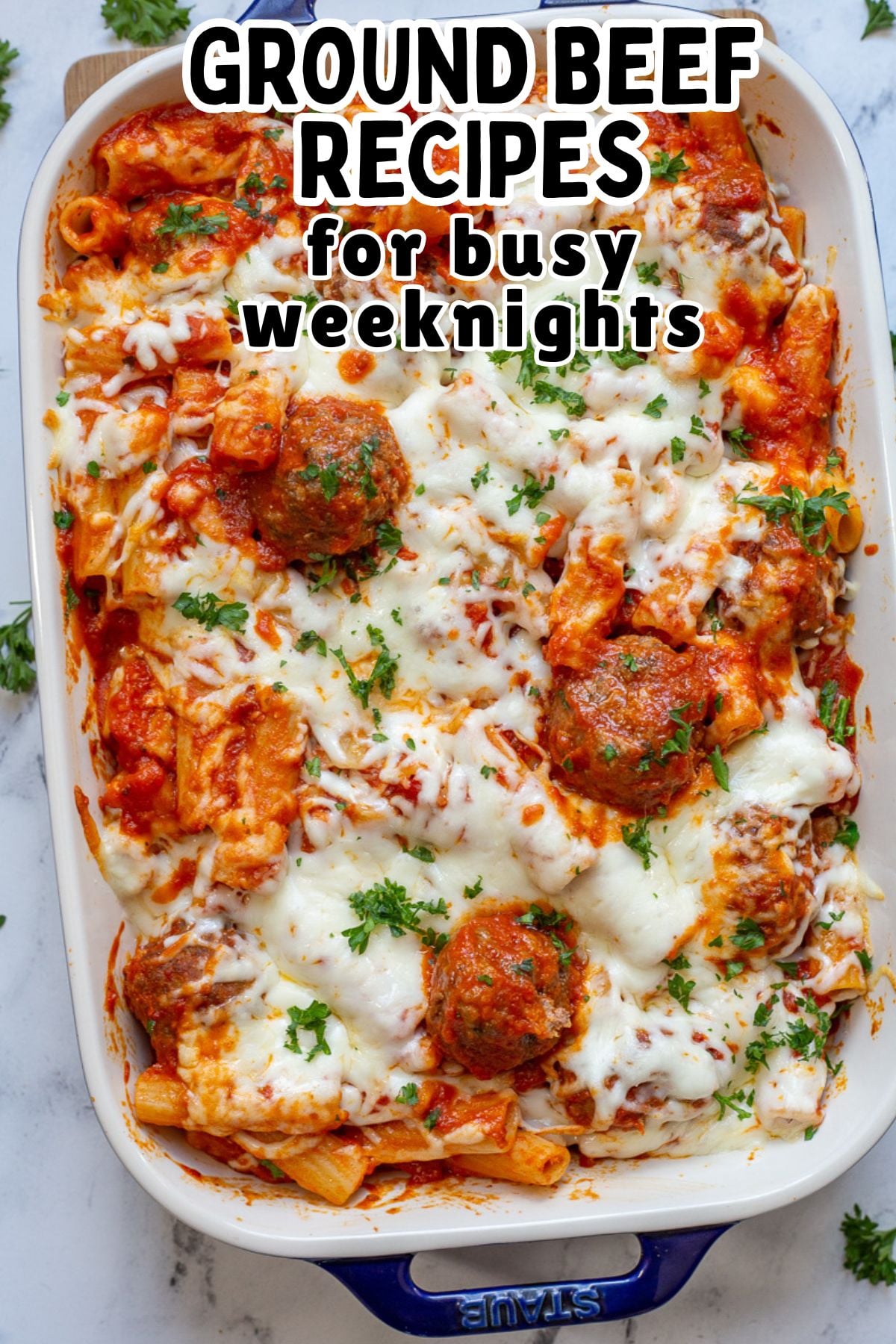 Baked ziti with meatballs in casserole dish.