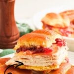 Turkey sliders on Hawaiian rolls stacked on a plate.
