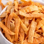Tortilla strips in a white bowl.