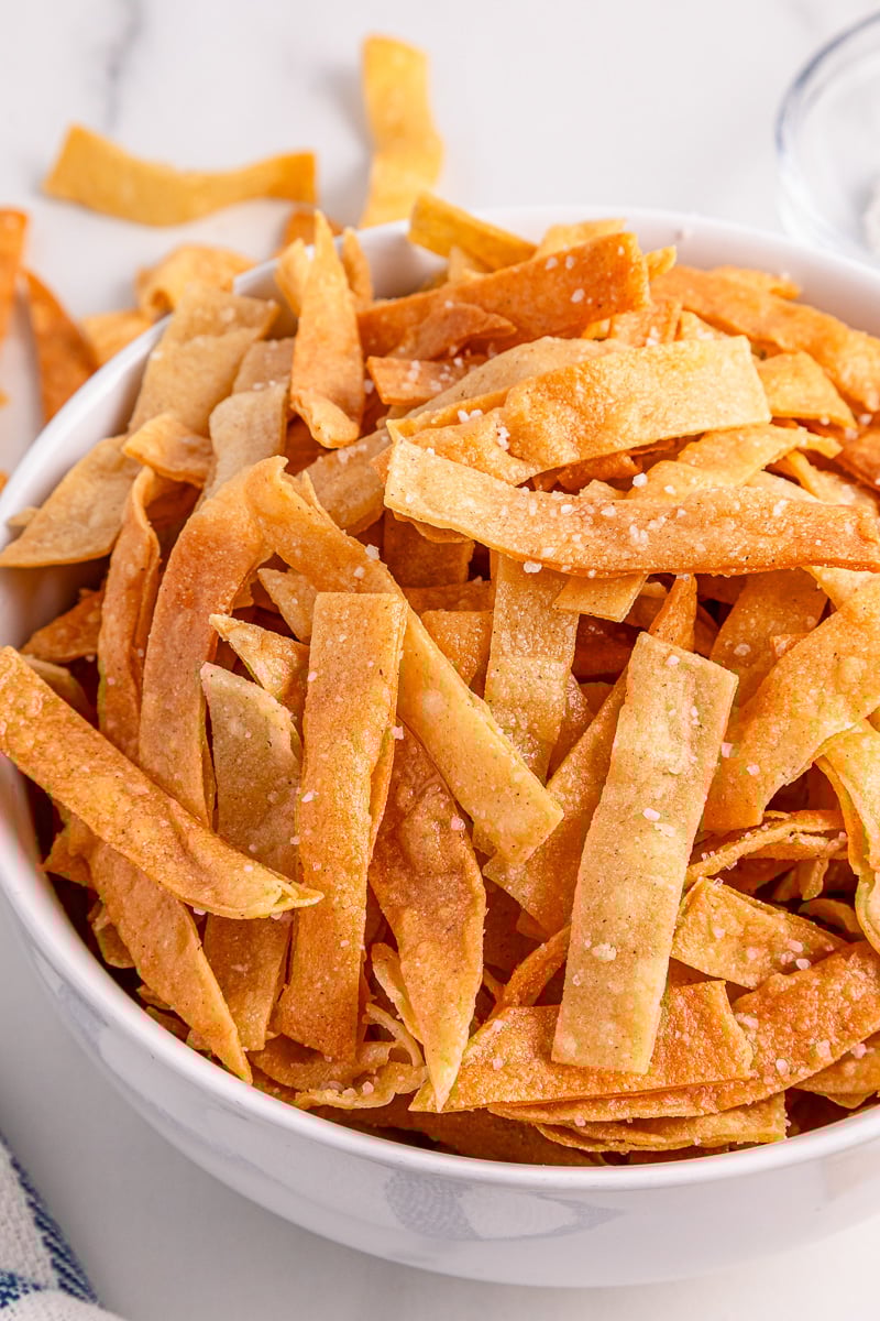 Tortilla strips in a white bowl.