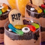 Halloween dirt cups sitting on table.
