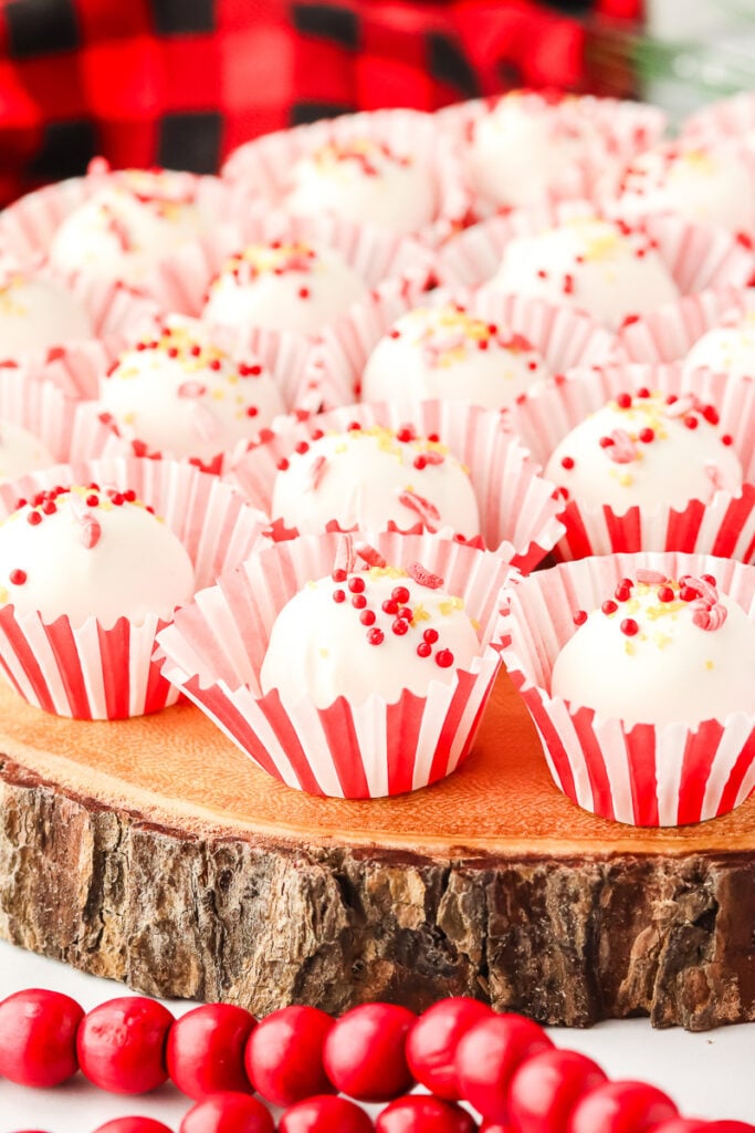 Peppermint truffles with cream cheese placed on a wooden board.