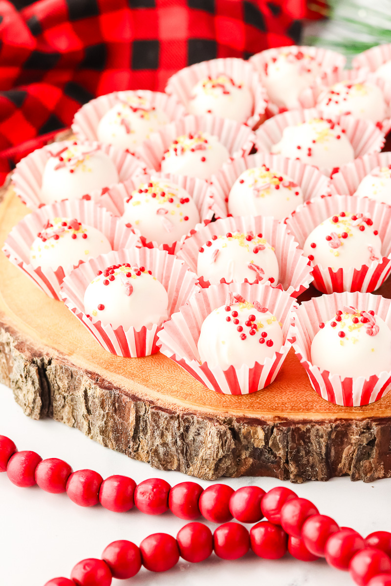 Peppermint cream cheese truffles on a wooden board.
