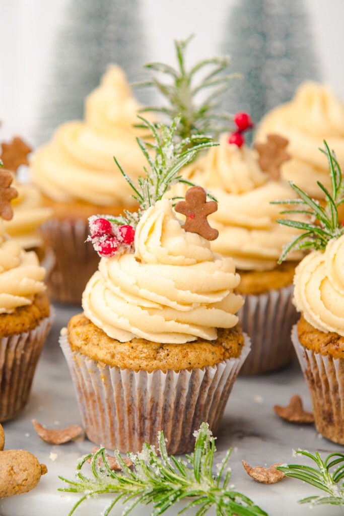 Gingerbread cupcakes in a group on a board.