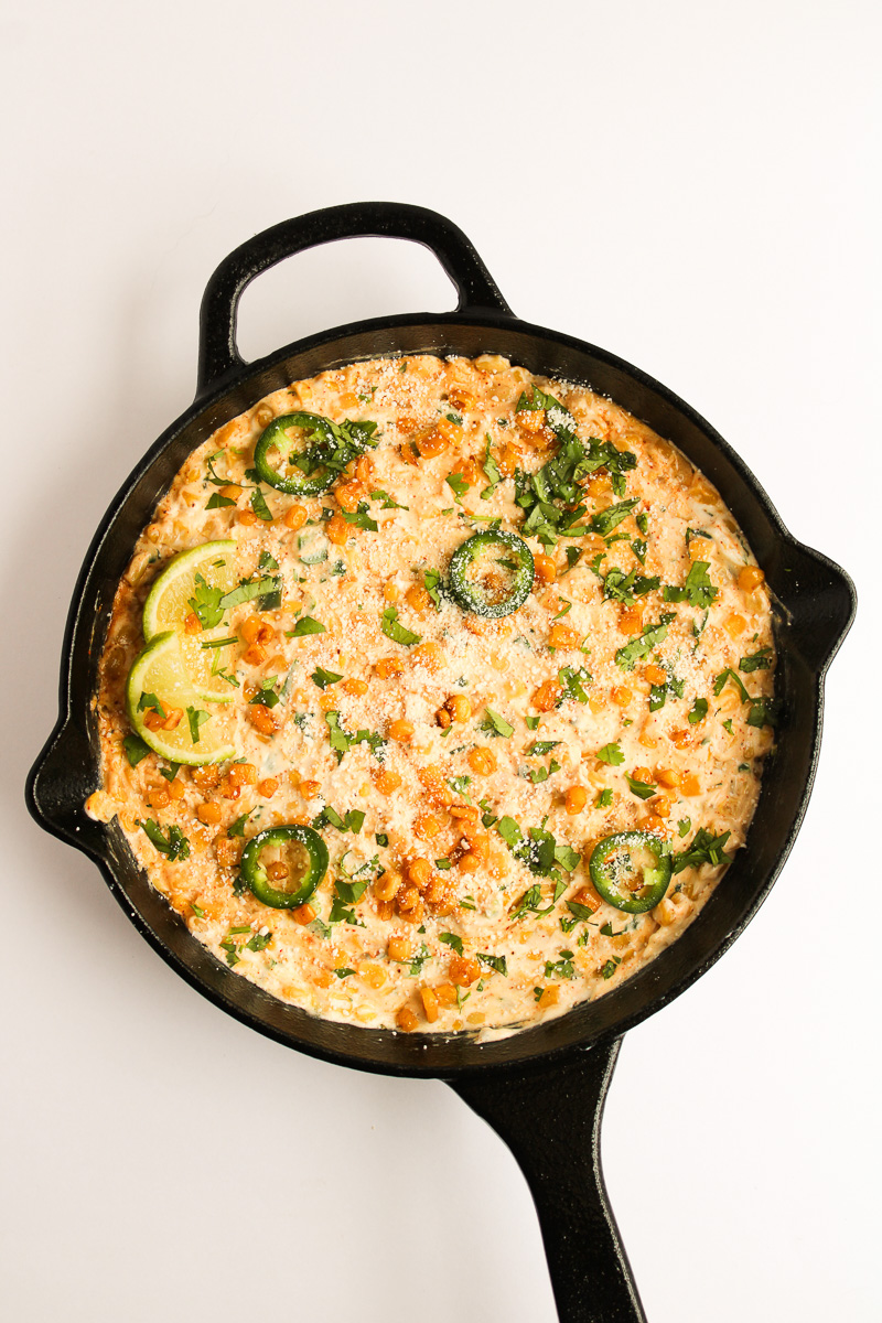 Baked Mexican street corn dip in cast iron skillet.
