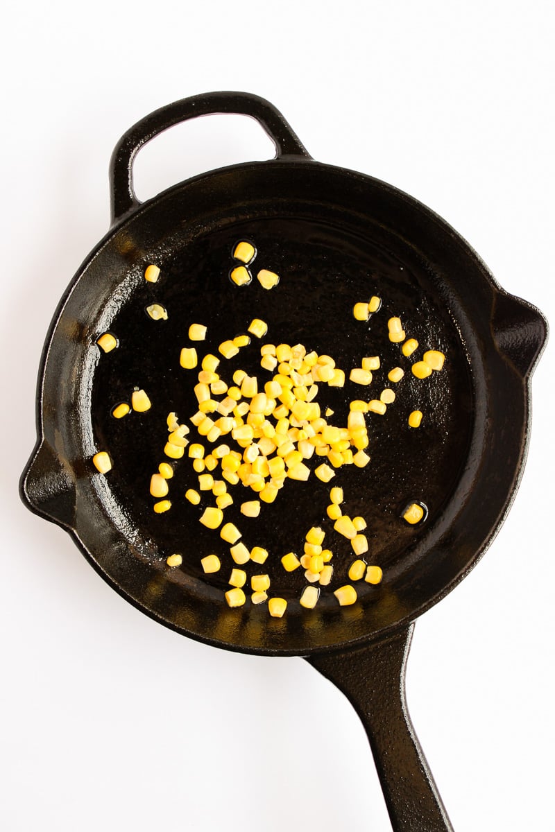 Corn in bottom of cast iron skillet.